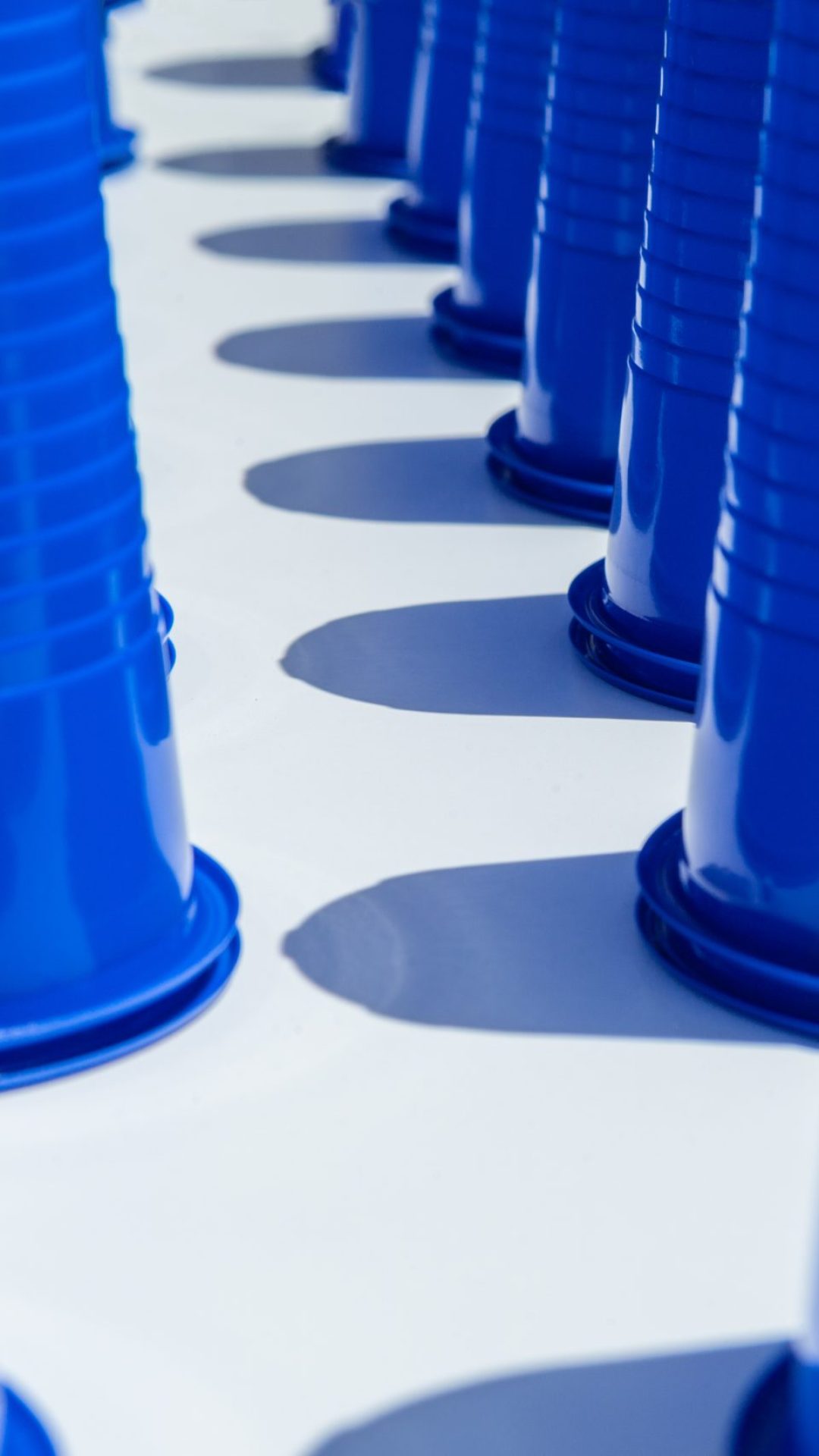 Blue Plastic Drinking Cups in rows background